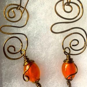 Swirl earrings with orange bead